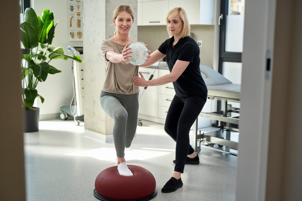 Caucasian female patient has workout with her therapist