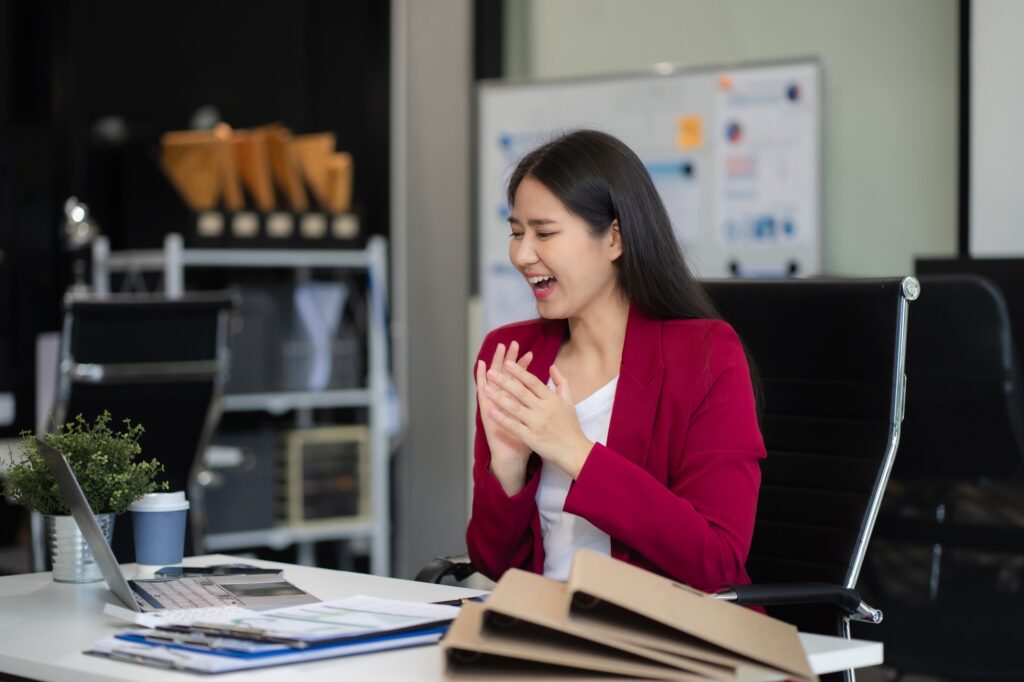 Happy woman, entrepreneur, small business owner working online.