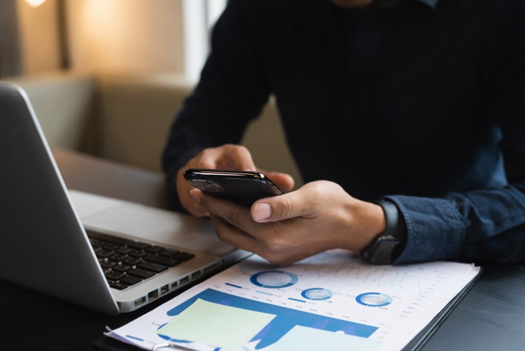 Businessman hand using smartphone, mobile payments online shopping, omnichannel, in office.